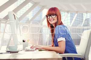 Composite image of smiling hipster woman typing on keyboard