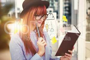 Composite image of smiling hipster woman writing notes