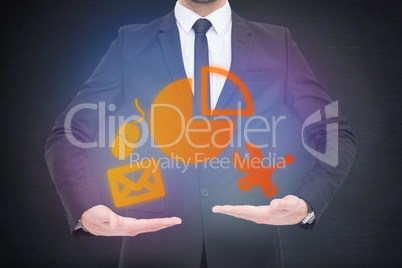 Composite image of mid section of a businessman holding somethin