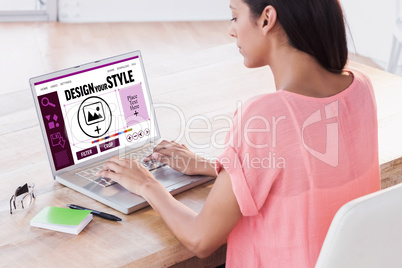 Composite image of businesswoman using laptop at desk in creativ