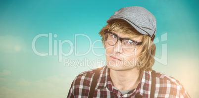 Composite image of serious blond hipster staring