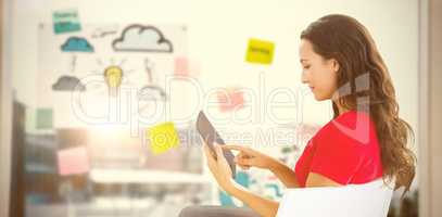 Composite image of woman sitting with tablet
