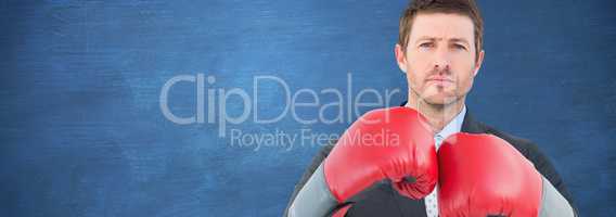 Composite image of businessman with boxing gloves