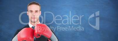 Composite image of businessman with boxing gloves