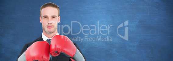 Composite image of businessman with boxing gloves