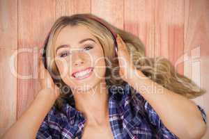 Composite image of portrait of a beautiful woman with headphones