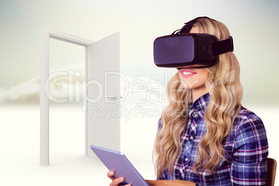 Composite image of pretty casual worker using oculus rift