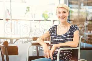 Composite image of smiling woman in a wheelchair