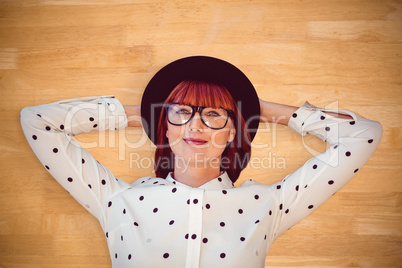 Composite image of attractive hipster woman lying on the floor