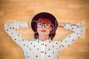 Composite image of attractive hipster woman lying on the floor