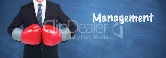 Composite image of businessman with boxing gloves