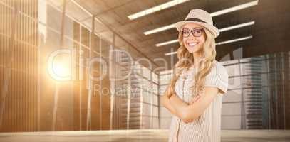 Composite image of gorgeous smiling blonde hipster with arms cro