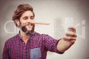 Composite image of happy hipster taking selfie