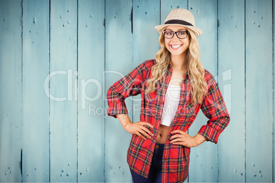 Composite image of gorgeous blonde hipster smiling with hands on