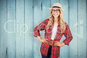 Composite image of gorgeous blonde hipster smiling with hands on