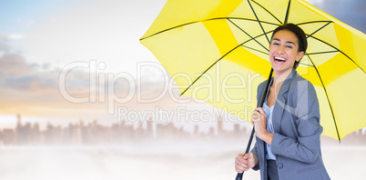 Composite image of portrait of happy businesswoman holding umbre