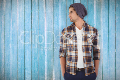 Composite image of confident hipster looking away while standing