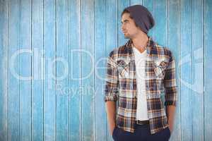 Composite image of confident hipster looking away while standing