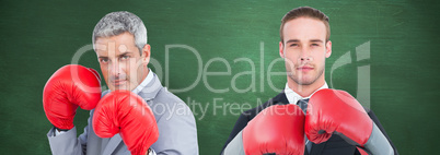 Composite image of businessman with boxing gloves