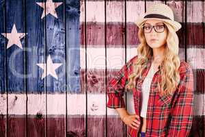 Composite image of gorgeous blonde hipster with hand on hips