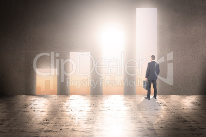 Composite image of businessman in suit looking through binocular