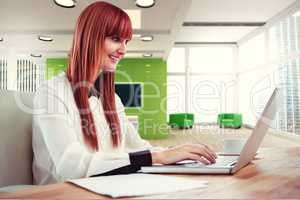 Composite image of smiling hipster businesswoman using her lapto