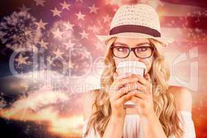 Composite image of gorgeous blonde hipster drinking out of take-