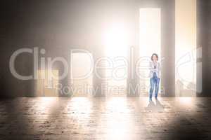 Composite image of businesswoman looking at camera with arms cro