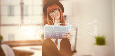 Composite image of smiling hipster woman using her tablet