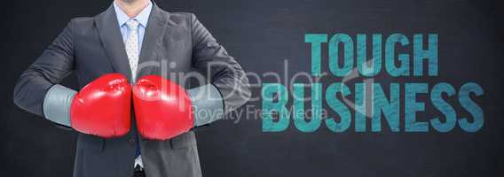 Composite image of businessman with boxing gloves