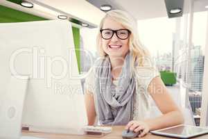 Composite image of portrait of smiling woman using computer