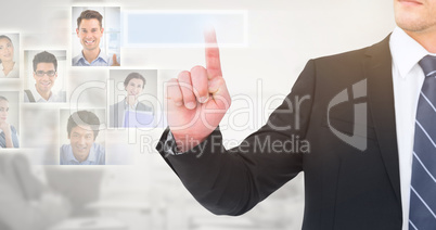 Composite image of unsmiling businessman pointing his finger