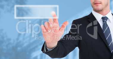 Composite image of focused businessman pointing with his finger