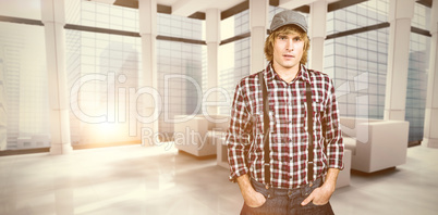 Composite image of serious blond hipster staring at camera