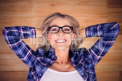 Composite image of gorgeous smiling blonde hipster lying
