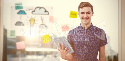 Composite image of handsome man with tablet