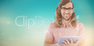 Composite image of portrait of happy hipster using digital table