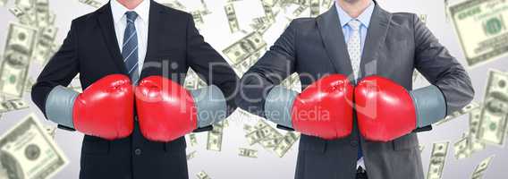 Composite image of businessman with boxing gloves