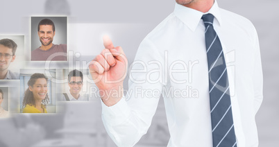 Composite image of businessman pointing with his finger