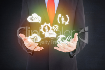 Composite image of businessman presenting with his hands