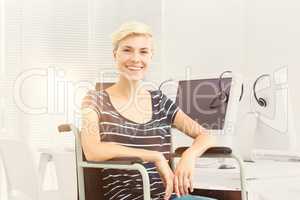 Composite image of smiling woman in a wheelchair