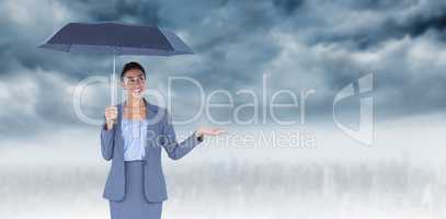 Composite image of smiling businesswoman holding umbrella