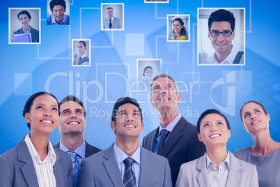 Composite image of business people looking up in office