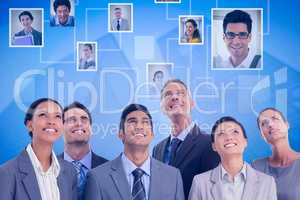 Composite image of business people looking up in office