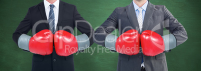 Composite image of businessman with boxing gloves