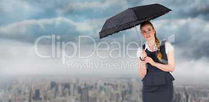 Composite image of pretty redhead businesswoman holding umbrella