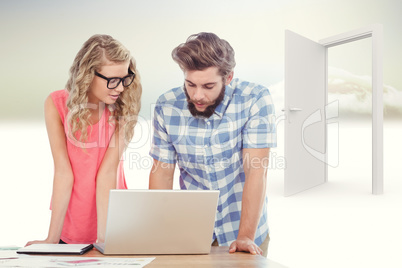 Composite image of man using laptop while discussing with woman