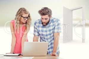 Composite image of man using laptop while discussing with woman