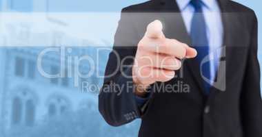 Composite image of businessman pointing his finger at camera