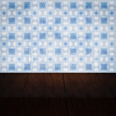 Wood table top and blur vintage ceramic tile pattern wall